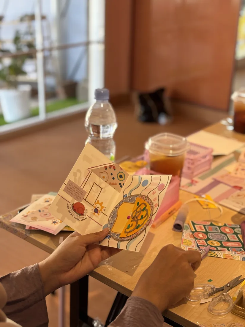 Hands holding a completed art zine